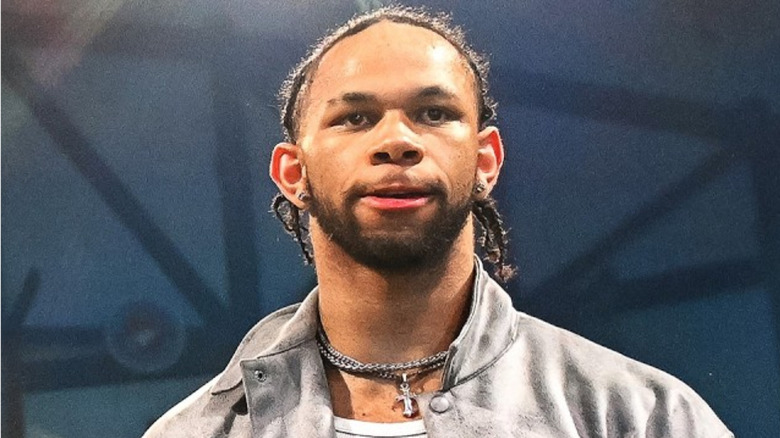 Leon Slater wearing a silver necklace