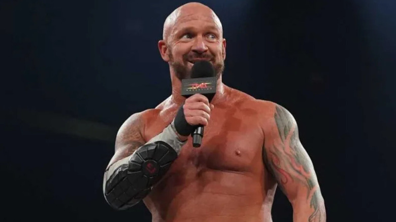Eric Young holding a microphone