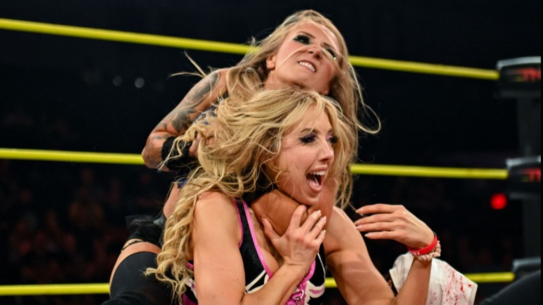 Heather by Elegance holds Allie in headlock