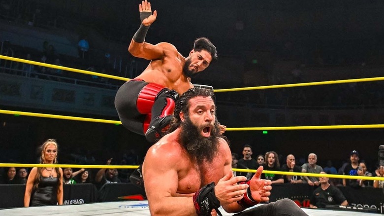 Mustafa Ali dropkicking Elijah