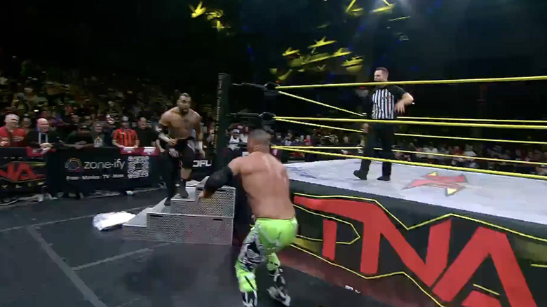 Santana flying off the ring steps to take out Kazarian