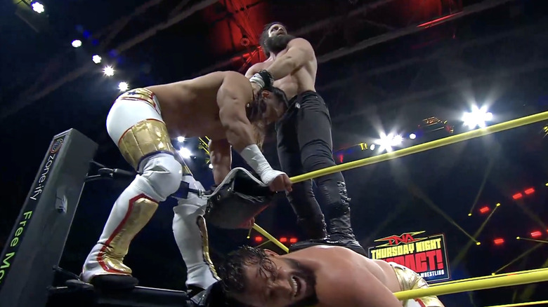 Elijah standing on Hotch and Skyler's spines