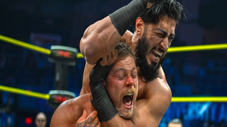 Mustafa Ali puts Adam Brooks in a headlock