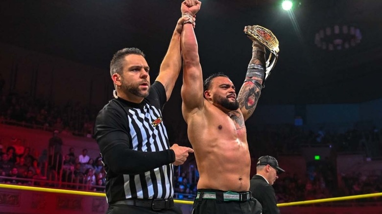 Mike Santana raises TNA World Title in the middle of the ring