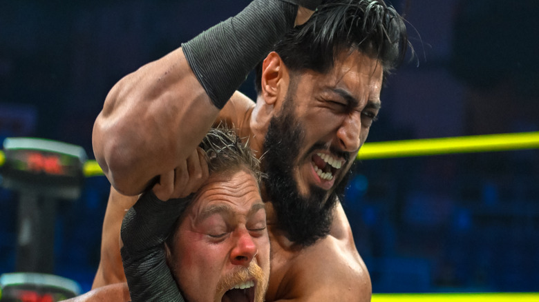 Mustafa Ali puts Adam Brooks in a headlock