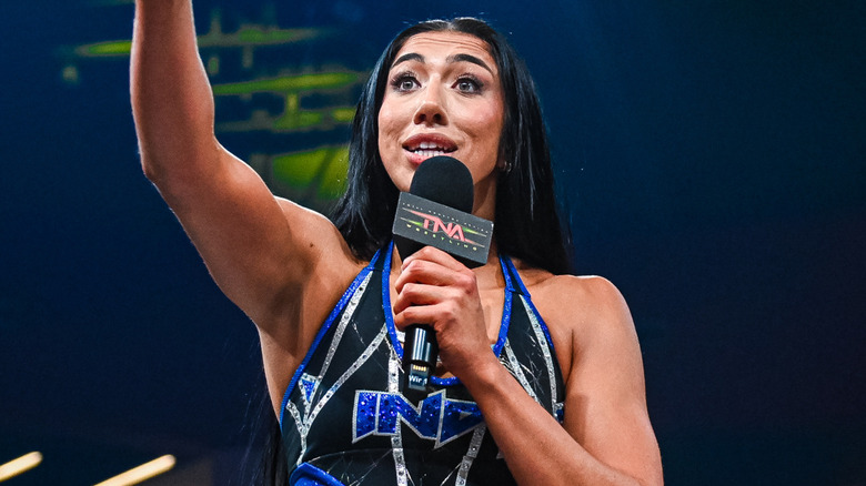 Indi Hartwell speaking into TNA mic