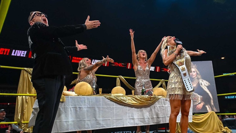 The Elegance Brand pose in the ring during a celebration on an episode of 