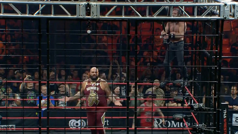 Elijah standing on the ropes behind Francis with his guitar in hand