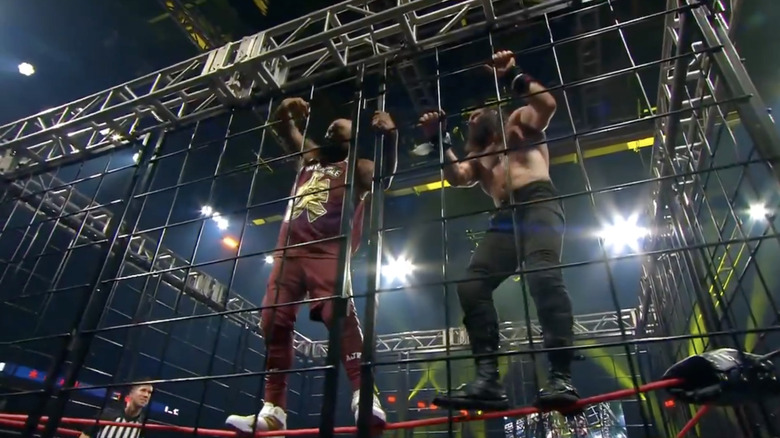 Francis and Elijah teetering on the middle rope
