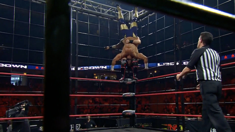 Hotch setting up for a piledriver on Ali off the middle rope