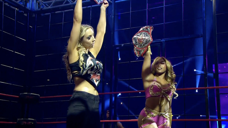 Allie and Hogan holding up with the Knockouts World Tag Team Championship belts