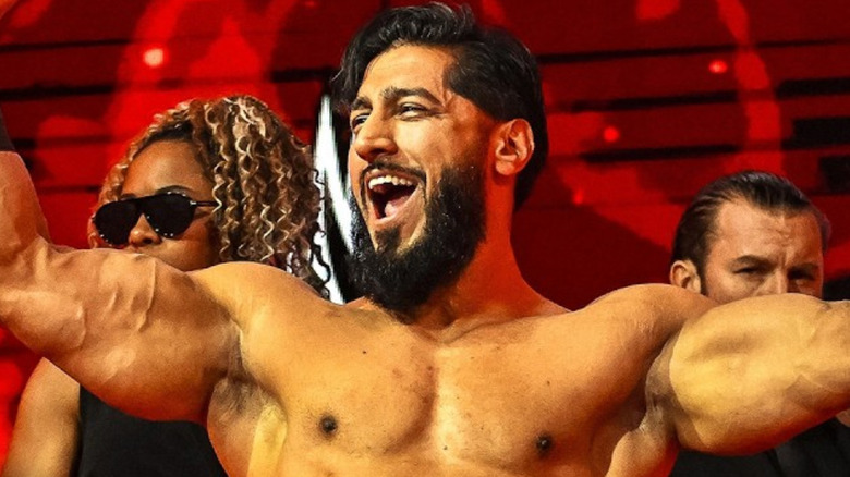 Mustafa Ali flexing his arms