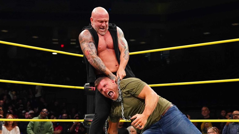 Steve Maclin is choked with a chain in the middle of the ring by Eric Young during an episode of 