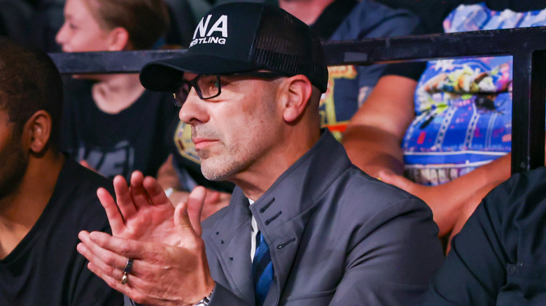 TNA President Carlos Silva claps during Joe Hendry's TNA World Heavyweight Title defense against Trick Williams