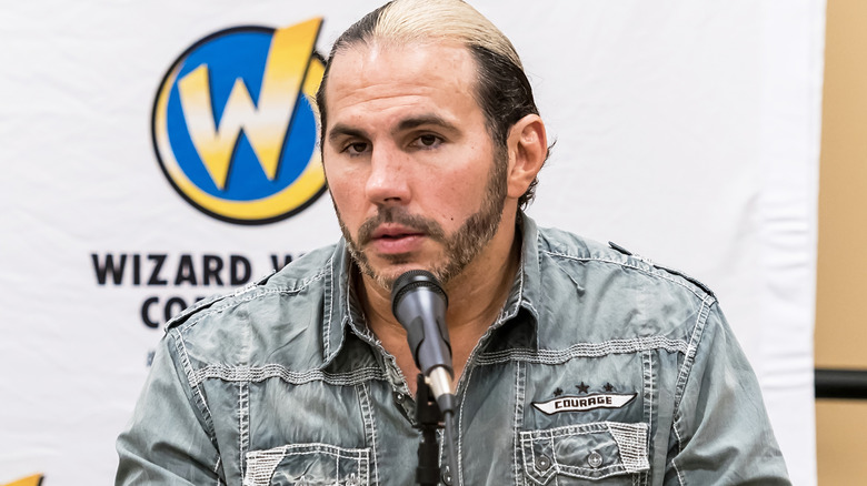 Matt Hardy sitting in front of a microphone