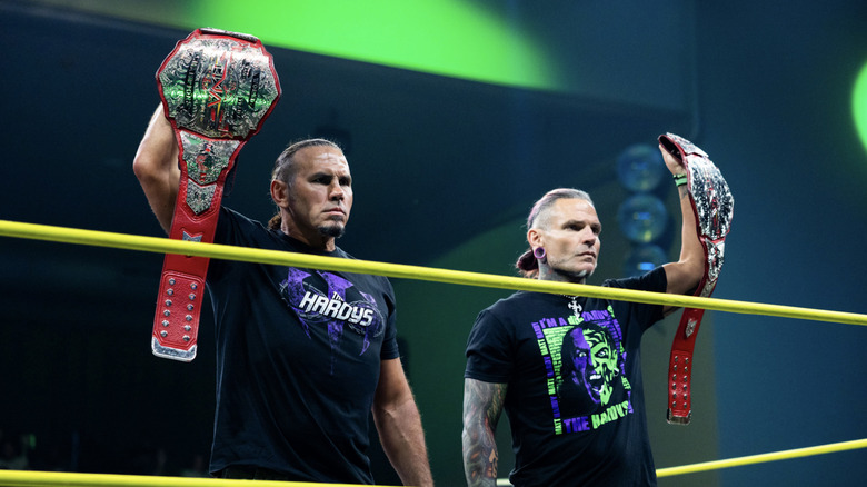 The Hardys holding up their TNA World Tag Team Championship belts