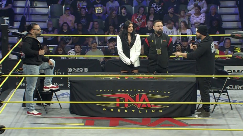 Santana and Eddie in the ring signing the contract