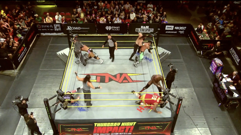 All eight men brawling with one another in the ring