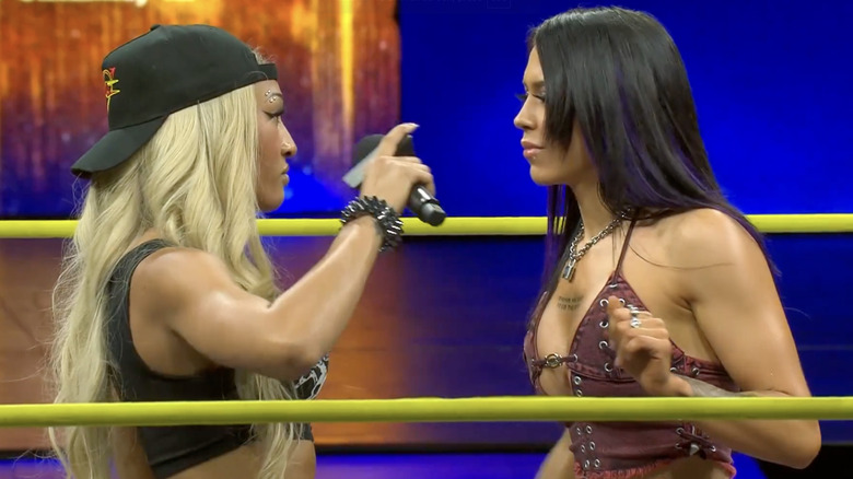 Sadè and Black staring one another down in the ring