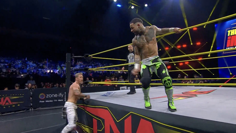 Miguel and Brooks brawling on the apron