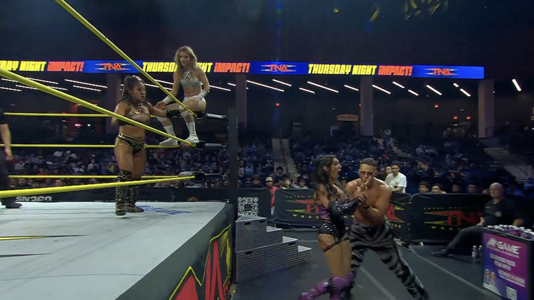 Lee and Brookside in the ring as Grace is on the outside with Stacks