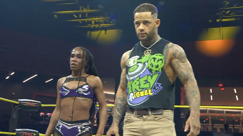 Stone and Miguel standing in the ring