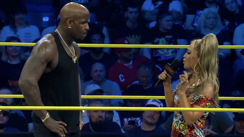 Moose and Alisha talking to one another in the ring