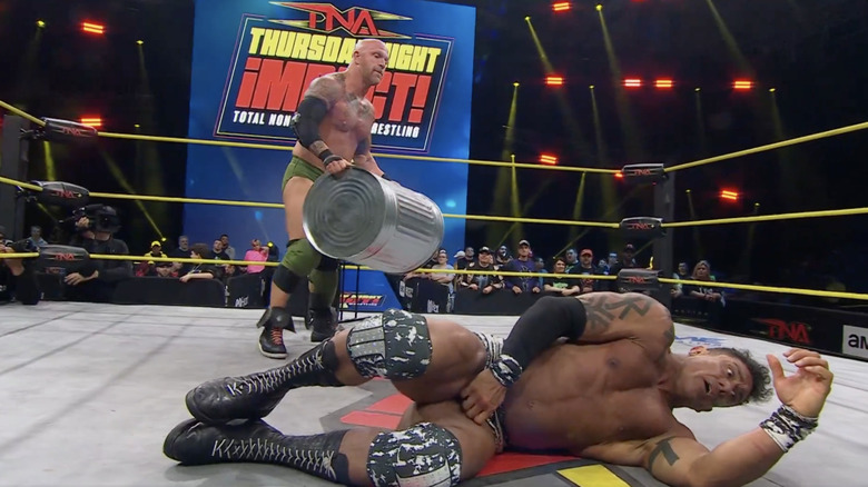 Young standing over EC3 with a garbage can