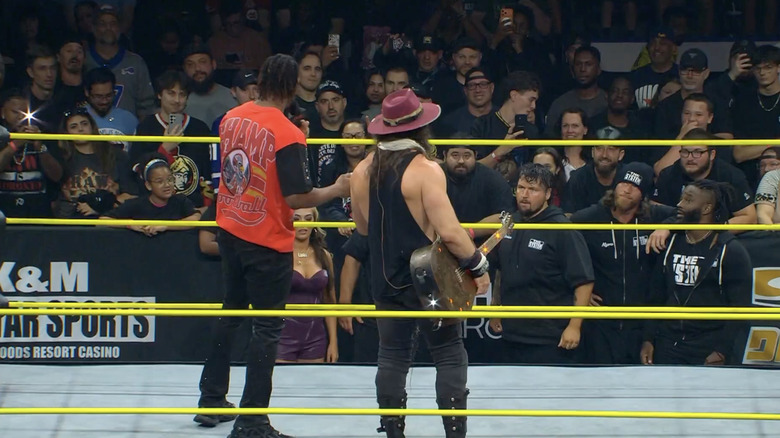 Sosa and Elijah in the ring as The System is on the outside
