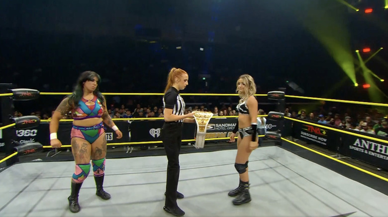 Forza and Brookside in the ring as the referee holds the Knockouts World Championship belt
