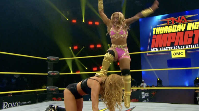 Hogan about to land a step-up leg drop on M
