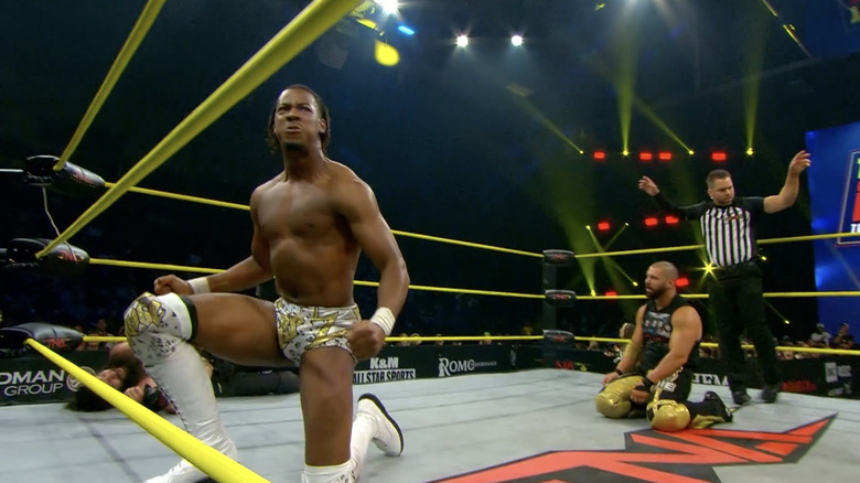 Sosa and Eddie both kneeling inside the ring