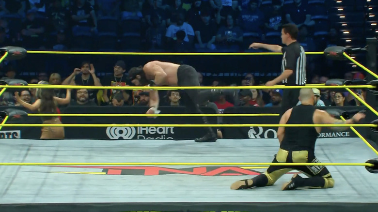 Elijah getting into the ring as Eddie is kneeling