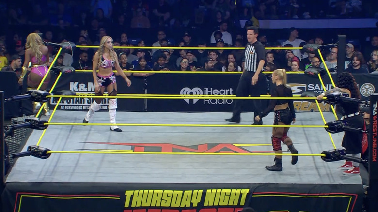 All four women inside and around the ring