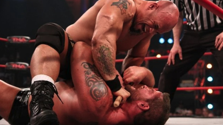 Hernandez holds wooden stick across Matt Morgan's throat at TNA Victory Road 2011
