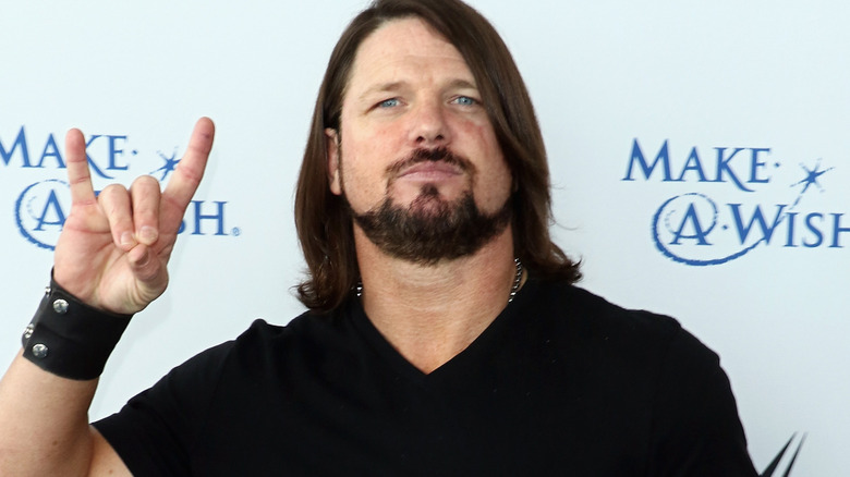 AJ Styles is forming a Too Sweet with his hand