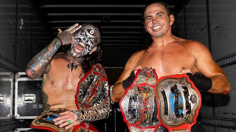 Jeff Hardy and Matt Hardy celebrating with a pair of championships backsatge.