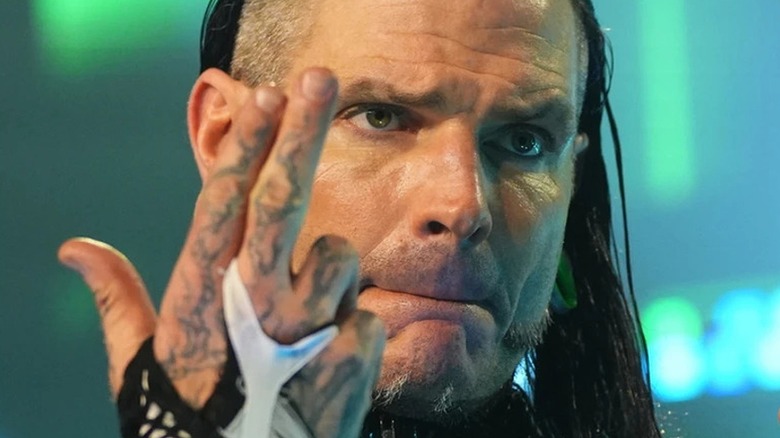 Jeff Hardy holding his signature 'guns up' pose during an AEW show.