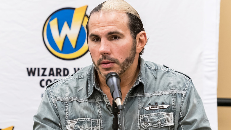 Matt Hardy sitting in front of a microphone