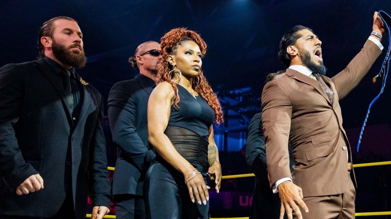 Mustafa Ali stands with the TNA International Championship in hand, the rest of Order 4 behind him, before an address to the fans on an episode of 