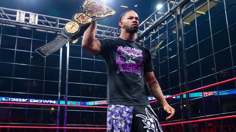 Leon Slater holding the TNA World title