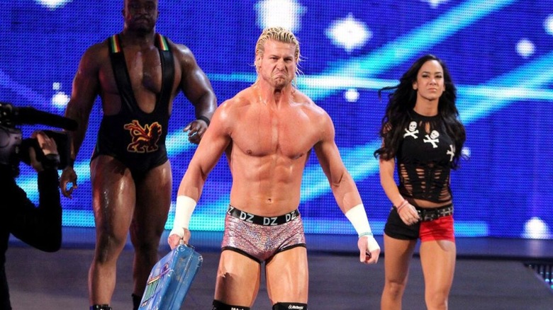 Flanked by Big E Langston and AJ Lee, Dolph Ziggler heads down the ramp, briefcase in hand, to cash in his contract on Alberto Del Rio in 2013.
