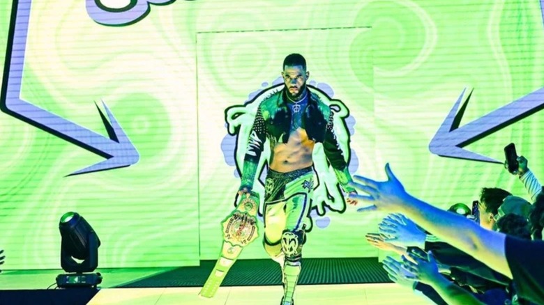 TNA International Champion Trey Miguel stand on the stand, title in hand, before a match on TNA programming.