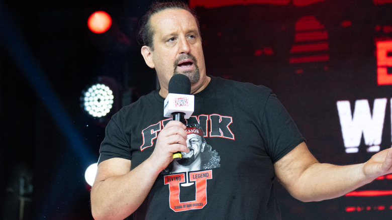 Tommy Dreamer holding a microphone