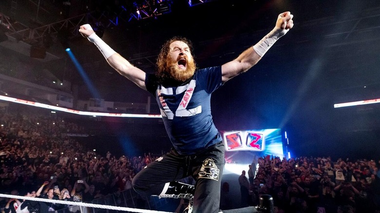Sami Zayn at the top of the turnbuckle, cheering towards the crowd ahead of a match.