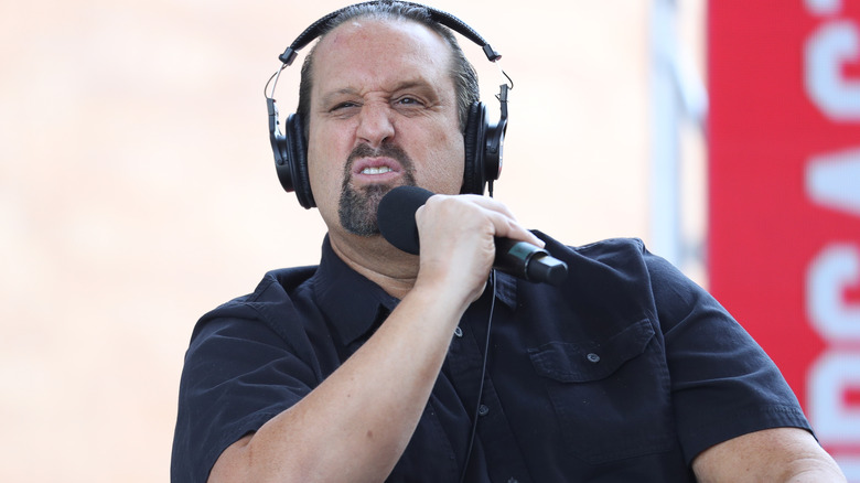 Tommy Dreamer snarls while wearing large headphones