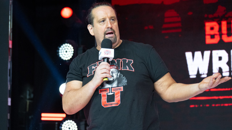Tommy Dreamer holding a microphone