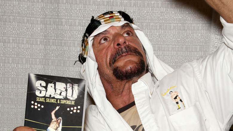 Sabu holding up his book