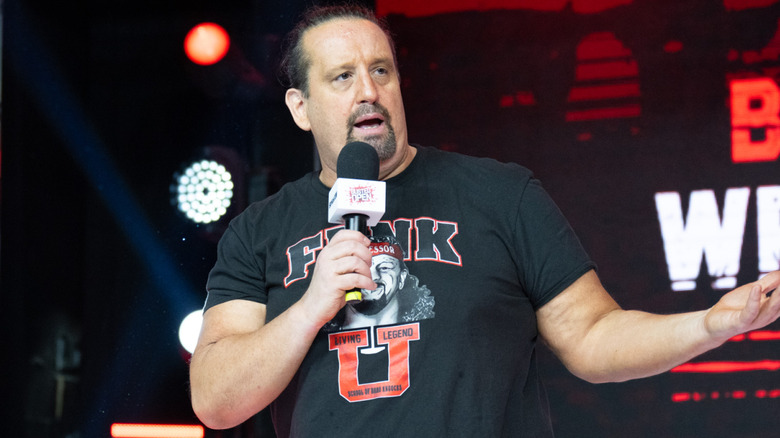 Tommy Dreamer holding a microphone
