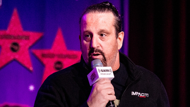Tommy Dreamer speaking into a microphone